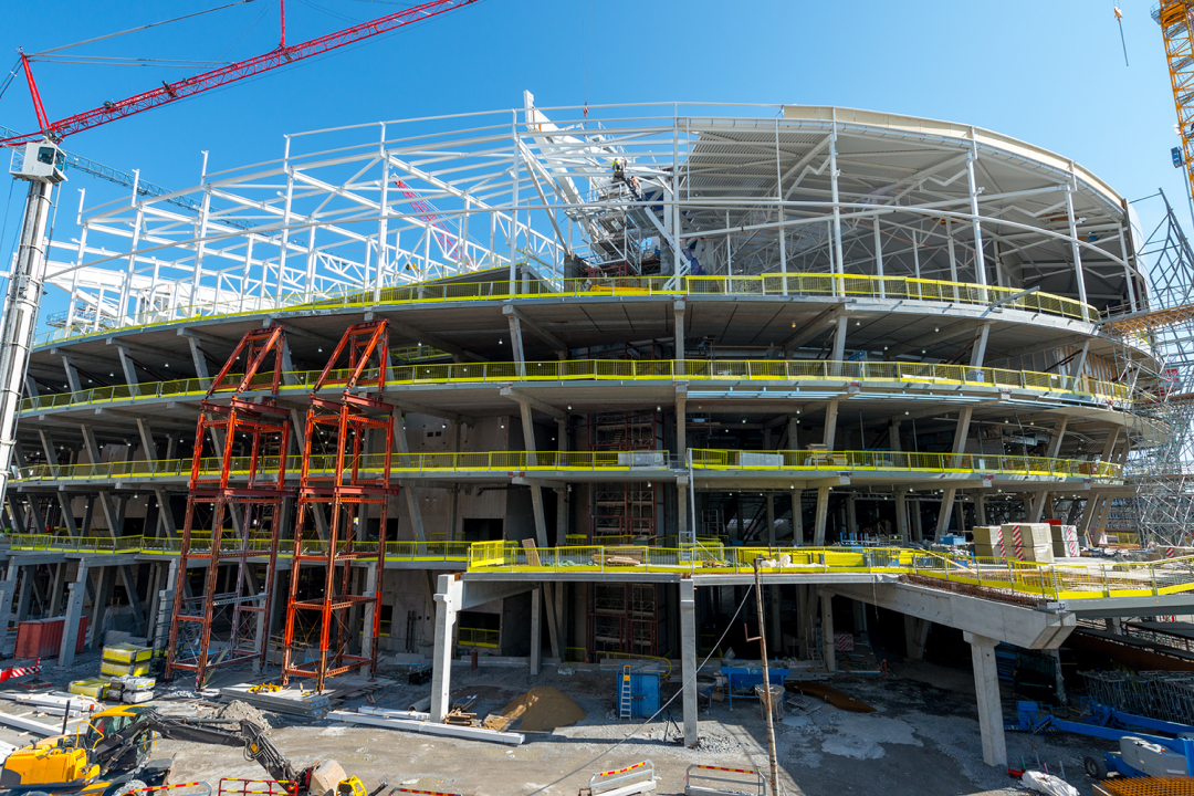 Construction site with cranes and heavy equipment in view