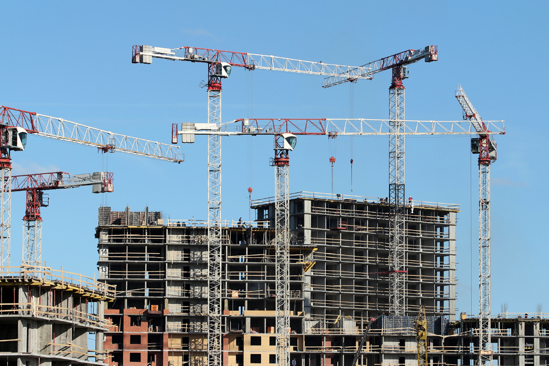 Cranes working on a mega construction project in an urban center.