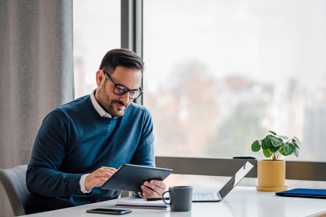 Young business man reviewing data on tablet computer