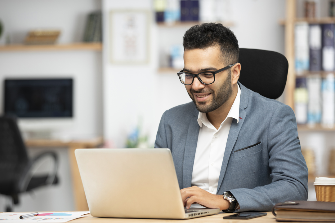 Contractor logging into a portal via his laptop