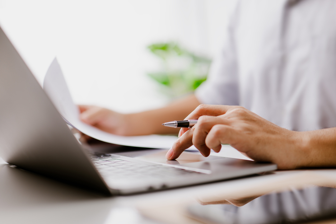 Contractor entering data on her laptop computer