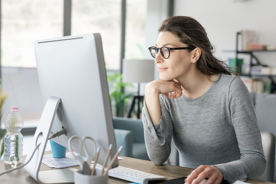 Woman analyzing project spend reports in office setting