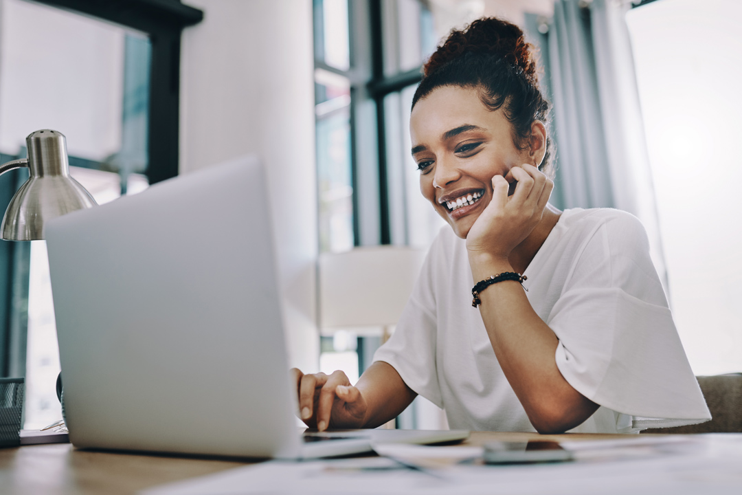 Young businesswoman using a laptop while working in her home office