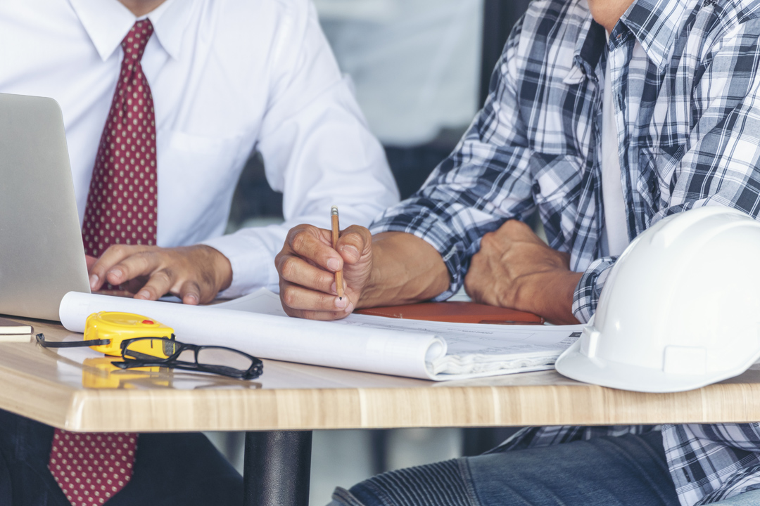 Construction engineers meeting together at construction site