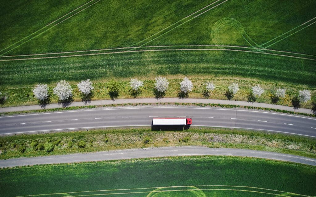 Tractor trailer driving down an empty highway